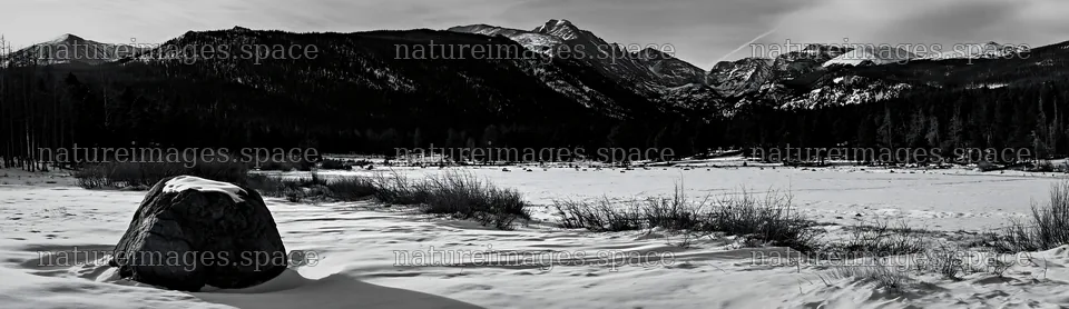 Snowy Rocky Mountain Park meadow with a large boulder – nature images 14762x4268
