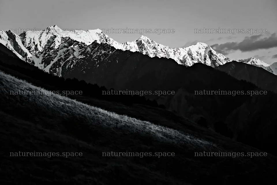 Sunset over mountains with snow and dark valleys – nature images 9722x6480