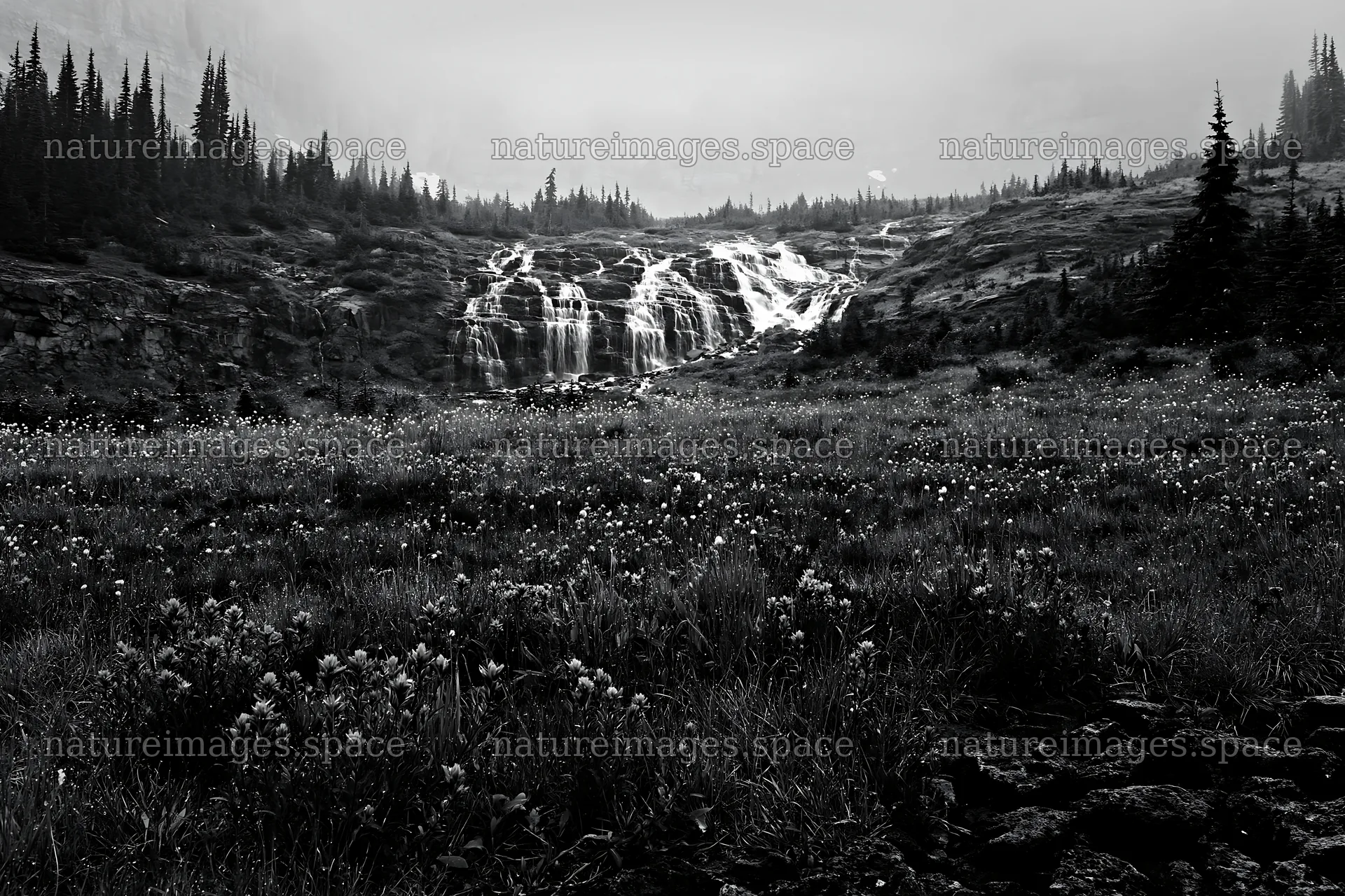Misty mountain waterfall in a meadow during overcast weather – nature images 9722x6480